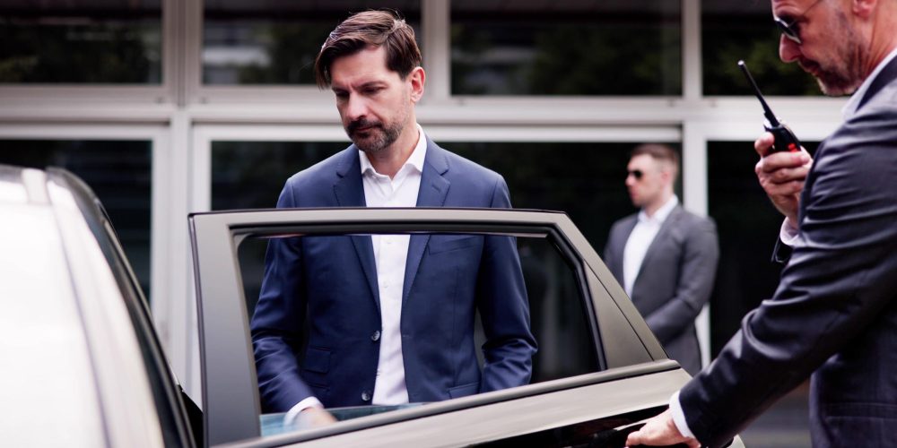 High-End Executive Vehicle Escort: VIP Protection Service Ensures Safety of Businessman with Handsome Bodyguards and Professional Security Measures.